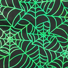 a black background with green spider webs on it