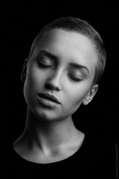 a black and white photo of a woman with her eyes closed