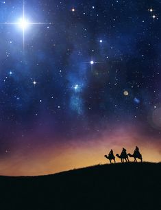 three people riding on camels under the stars