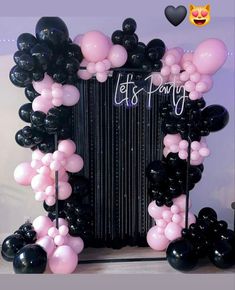 an accordion decorated with black and pink balloons