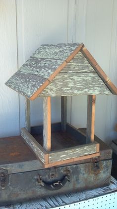 an old suitcase with a little house on top