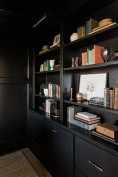 a black bookcase with many books on it