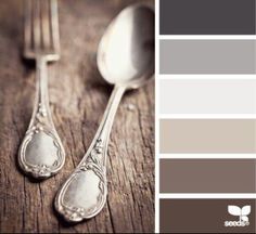 two spoons and a fork on a wooden table with color swatches in the background