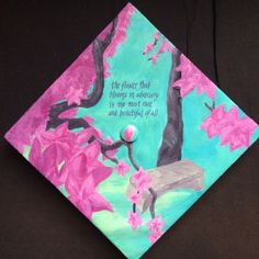 a colorful graduation cap decorated with pink flowers and a poem on it that reads, the flower that blooms in memory is my most rare and beautiful y'all