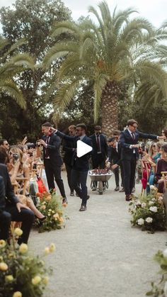 two men in suits are walking down the aisle with their arms out to each other