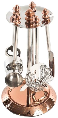 a metal and glass holder with two bells on the top, one is holding an object