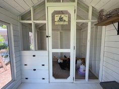 the inside of a small white house with lots of windows and doors on both sides