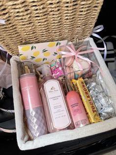 an open suitcase filled with personal care products and candy bar wrapped in twine ribbon