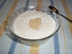 a glass bowl filled with white liquid on top of a table