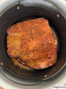 a large piece of meat is cooking in a slow cooker