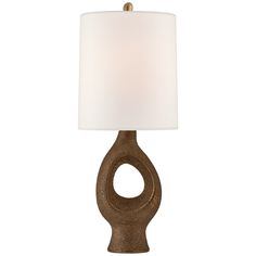 a table lamp with a white shade on the top and an oval shaped light in the middle