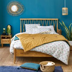 a bed room with a neatly made bed and a basket on the floor next to it