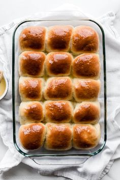 a glass baking dish filled with bread rolls