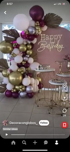 an image of a birthday party with balloons on the wall and tables in front of it