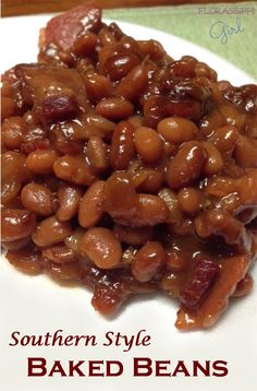 baked beans on a white plate with the words southern style baked beans in red lettering