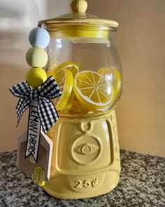 a lemonade dispenser is sitting on a counter with some decorations around it