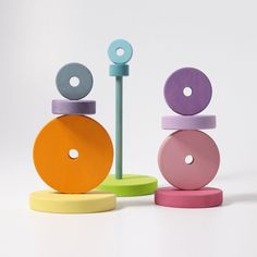 an assortment of colorful wooden toys sitting on top of each other