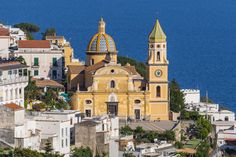 an aerial view of a church in the middle of town next to the water and buildings