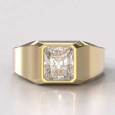 a yellow gold ring with a square cut diamond in the center, on a white background