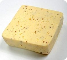 a block of cheese sitting on top of a white table