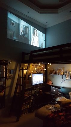 a loft bed with a tv on the wall