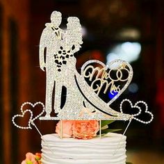 a wedding cake topper with the bride and groom on it