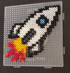 this is a lego bead art piece that looks like an image of a rocket ship