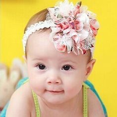 a baby girl with a flower in her hair