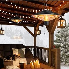 a living room filled with furniture and lit candles on top of a wooden table next to a christmas tree