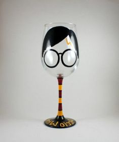 a wine glass with harry potter glasses on it