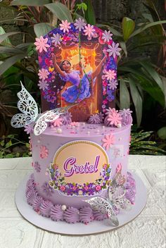 a purple cake with an image of a princess on top and butterflies around the edges