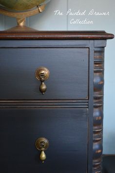 an antique dresser with brass pulls and knobs is painted dark blue by the painted drawer collection