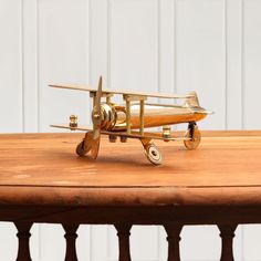 a toy airplane sitting on top of a wooden table