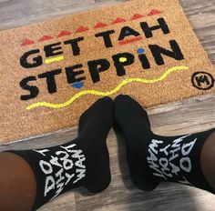 someone is standing in front of a door mat that says get tah stepin