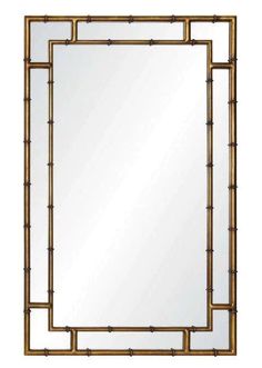 a square mirror with gold frame and bamboo decoration on the bottom, against a white background