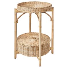 a round wicker table with two baskets on the bottom and one shelf below it