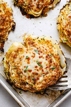 some food that is sitting on a pan with a fork in it and has been cooked