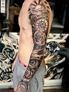 a man with a clock and roses tattoo on his arm is posing for the camera