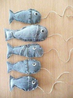 three fish made out of jeans on a wooden table with string attached to them and the caption reads, i can't decide if it is denim or not