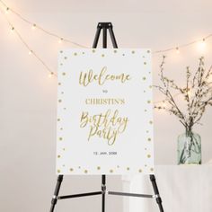 a welcome sign is displayed on an easel in front of a decorated christmas tree