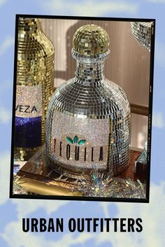 an image of a bottle that is covered in sequins and has the words urban outfitters on it