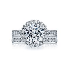 a diamond engagement ring with two rows of diamonds on the band and an oval center stone surrounded