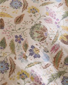 an image of a flowered fabric with leaves and flowers on the bottom half of it