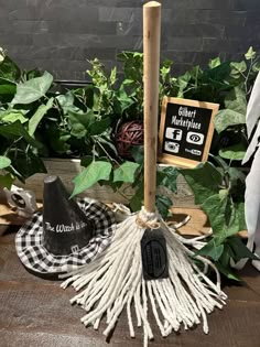 a black and white hat, broom, and other items are sitting on a wooden table