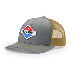 a grey and tan hat with the word skre on it's front side