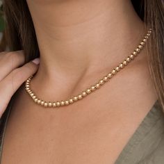 Elevate your jewelry collection with our exquisite 14k solid gold ball bead necklace, designed with an internal gold chain for enhanced strength. This beautifully crafted piece features a series of gold beads that create a timeless look. Perfect for layering or wearing alone, the necklace adds a touch of sophistication to any outfit. It's a luxurious addition that makes for a thoughtful gift for yourself or someone special. ∙NECKLACE DETAILS∙ * Material: 14k Solid Gold ("585" EU authenticity sta Layered Chains, Gold Bead Necklace, Ball Necklace, Christmas Gift Jewelry, Wedding Jewellery Necklace, Matching Bracelets, Gold Beads, Wedding Necklace, Beaded Chain