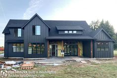 a large black house with lots of windows and sidings on the side of it