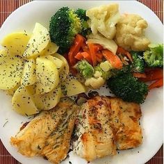 a white plate topped with chicken, potatoes and broccoli