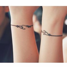 two people with matching tattoos on their wrists