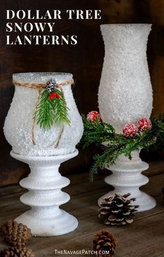 two white vases with pine cones and holly on them, one has a christmas decoration